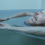 Woman floating in sensory deprivation tank