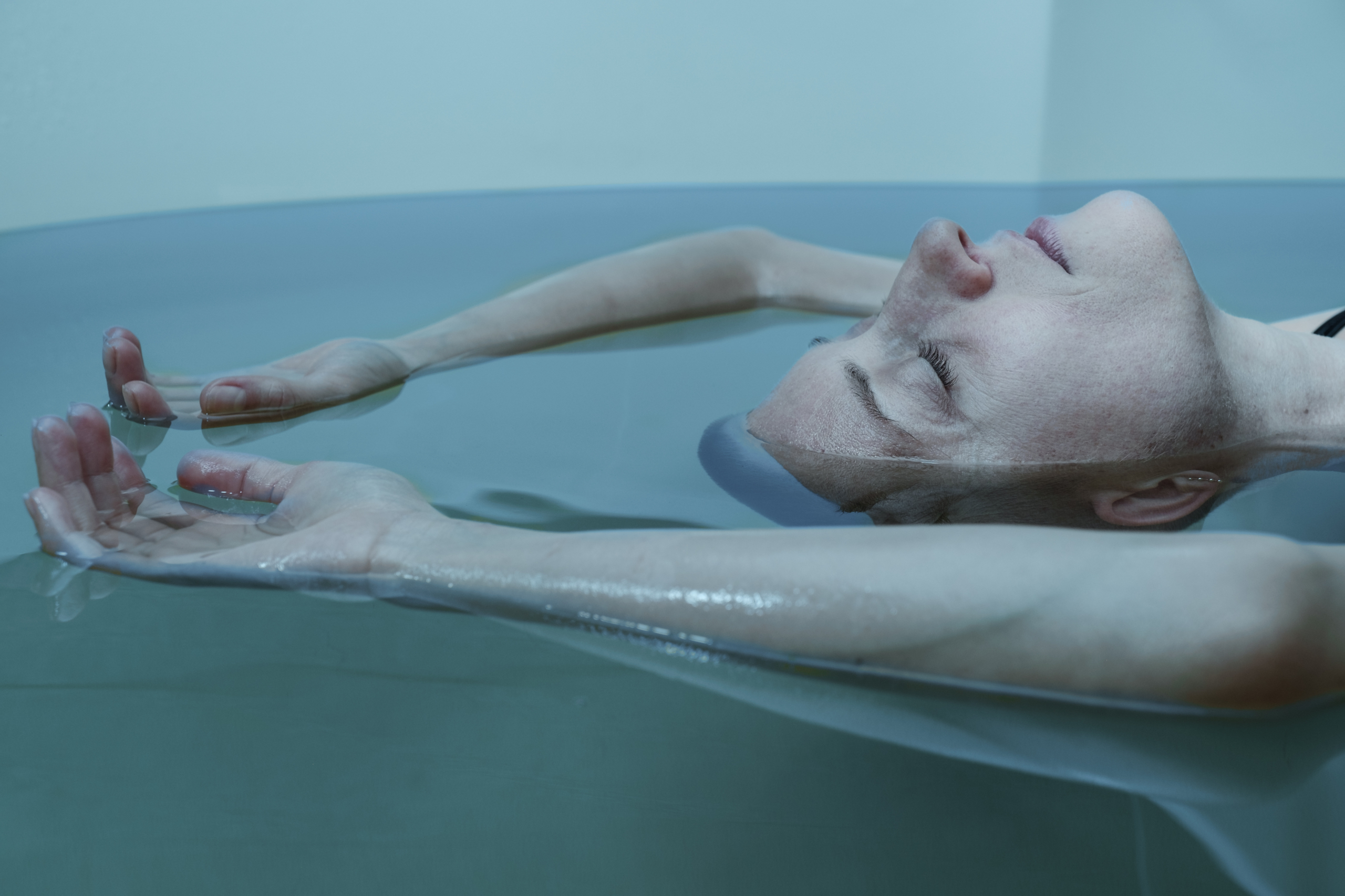 Woman floating in sensory deprivation tank